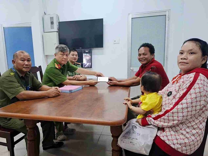 Thành viên lực lượng tham gia bảo vệ an ninh, trật tự ở cơ sở mang điện thoạt nhặt được đến công an phường để tìm người đánh mất. Ảnh: Công an Đông Hải