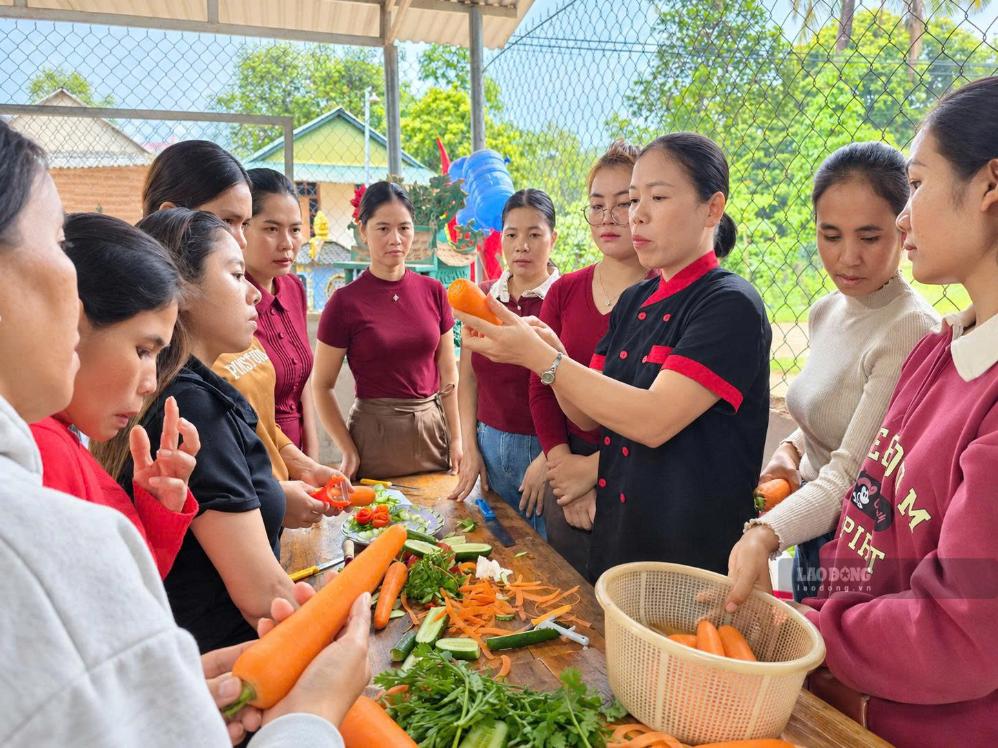 Các học viên hào hứng thực hành cắt tỉa, trang trí món ăn dưới sự hướng dẫn của giáo viên ngay tại nhà dân ở thôn A Ngo (ảnh chụp tháng 9.2026). Ảnh: Hưng Thơ