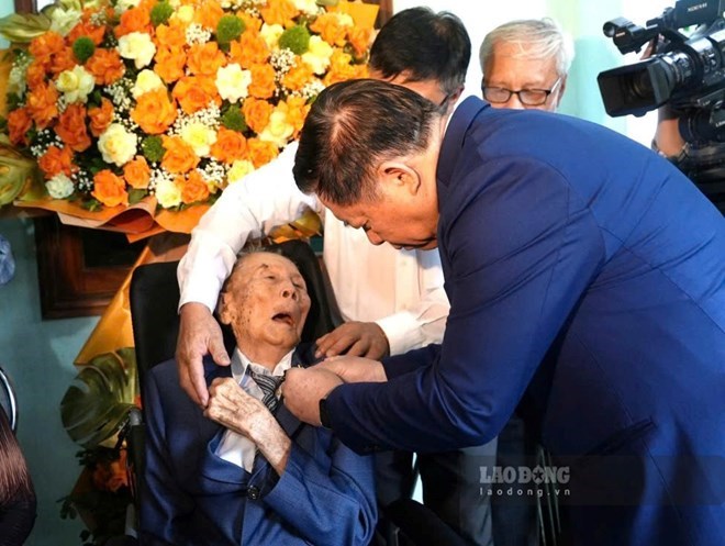 Đại tướng Nguyễn Trọng Nghĩa - Ủy viên Bộ Chính trị, Bí thư Trung ương Đảng, Chủ nhiệm Tổng cục Chính trị Quân đội nhân dân Việt Nam - trao Huy hiệu 80 năm tuổi Đảng cho đảng viên Nguyễn Anh Hùng ở xã Nam Gianh, tỉnh Quảng Trị. Ảnh: Tân Hướng