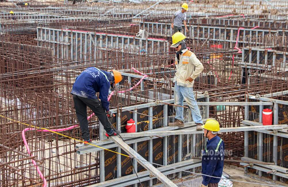 Dejando de lado las vacaciones con la familia, los trabajadores hacen horas extras para construir el puerto de My Thuy