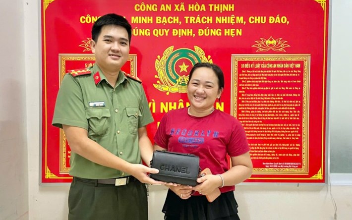Nữ du khách nhận lại tài sản bị đánh rơi nhờ một học sinh lớp 4 ở Đắk Lắk nhặt được. Ảnh: Công an xã Hòa Thịnh

